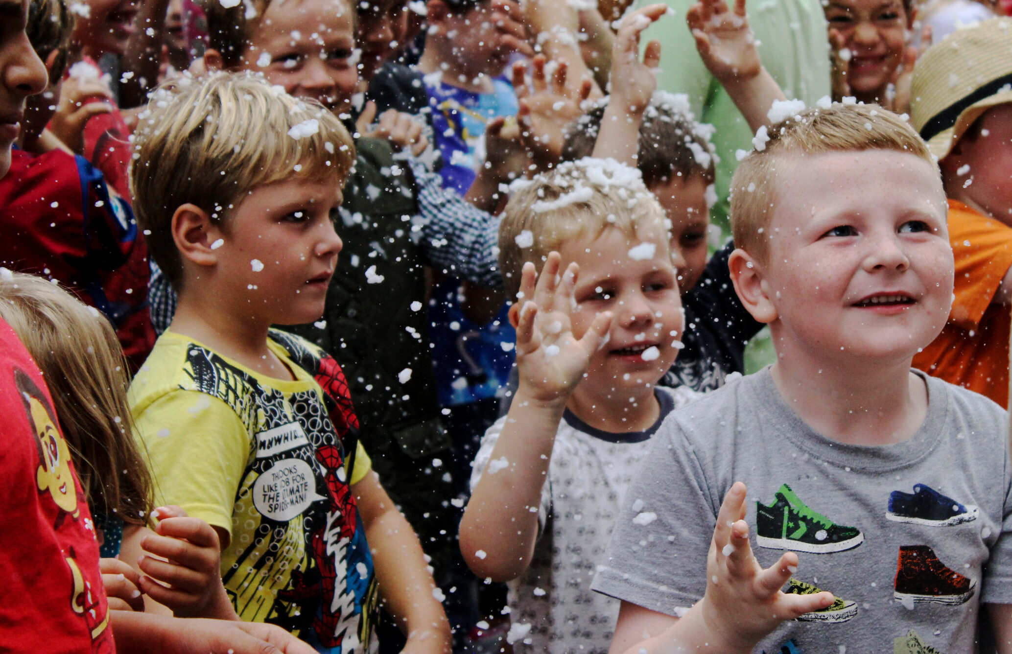 Group of boys celebrating in crowd