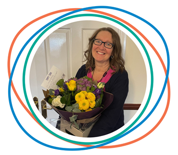 Flintshire foster carer receiving flowers after long service to fostering